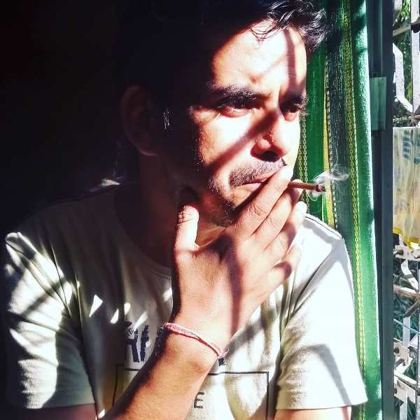 Brahma Mishra smoking a cigarette